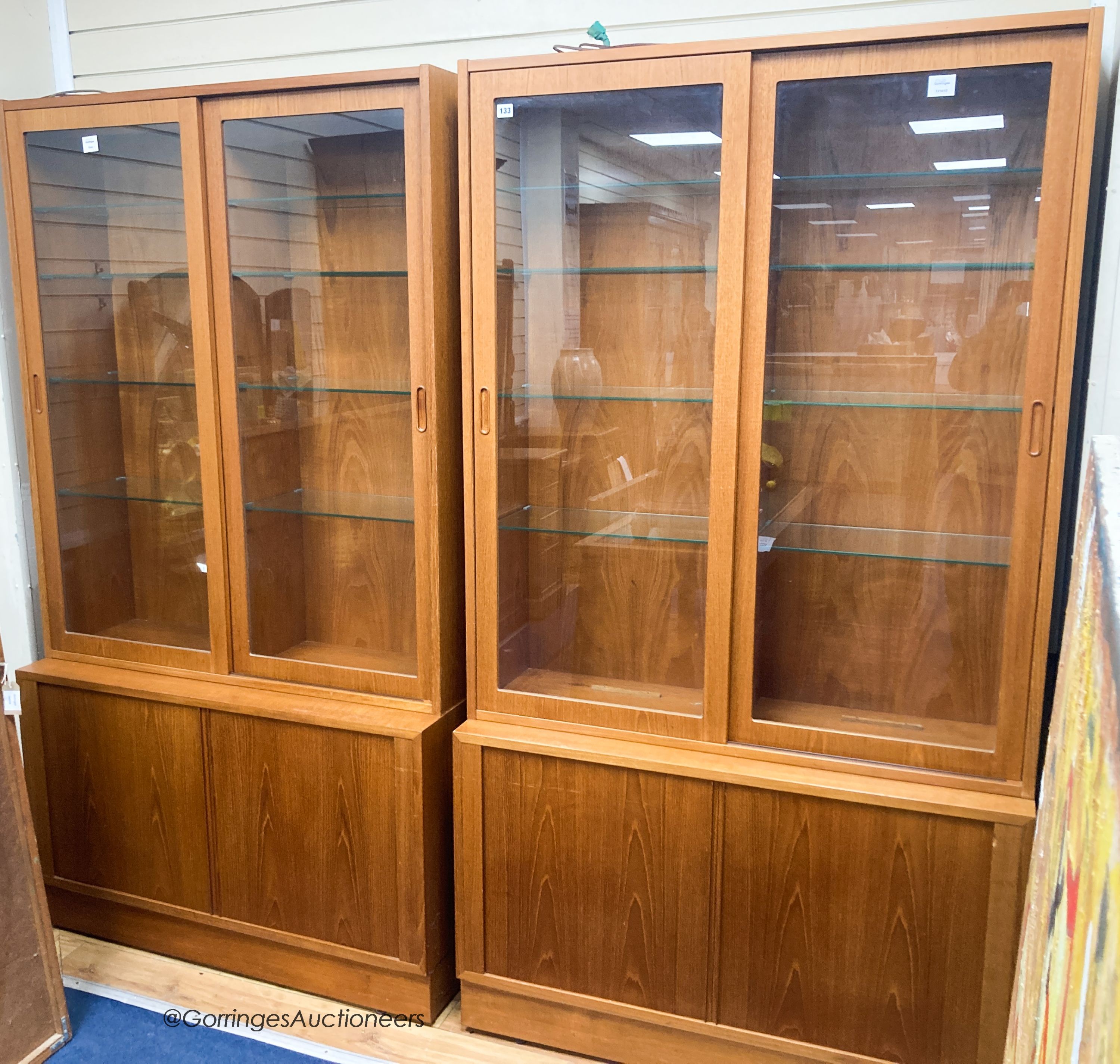 A pair of Harrods teak display cabinets, width 108cm, depth 43cm, height 196cm